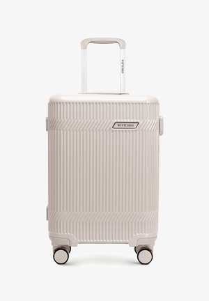 Maleta rígida beige con ranuras verticales, cuatro ruedas, asa telescópica y logo "Wittchen" en la parte frontal y en el asa.