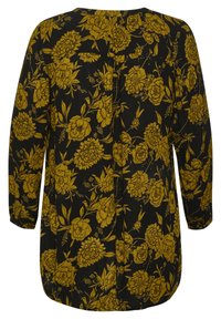 Zwarte bloemen tuniek met gele pioenroos patroon, lange mouwen, afgeronde zoom en rugplooien voor gemakkelijke beweging. Lichtgewicht stof.