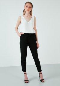 LELA REGULAR FIT - Hlače - black