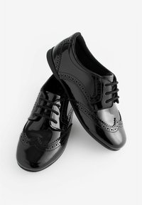 Schwarze Lackleder-Brogues mit filigranen Aussparungen, runder Zehenform und passenden Schnürsenkeln. Glatte Textur und glänzende Oberfläche.