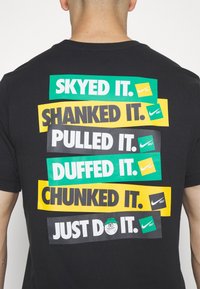 Nike Golf Triko s potiskem - black