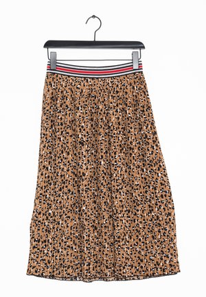 Pleated midi skirt made of fabric with a brown base and black, white, and tan leopard spots. It features a striped waistband in red, black, and white.