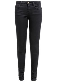 Jean skinny noir avec poches avant, passants de ceinture et fermeture à bouton, présenté sur fond blanc.