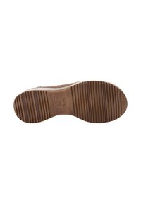 Brown rubber shoe sole with textured grooves for traction. Features brand logo embossed on the bottom and a smooth edge.