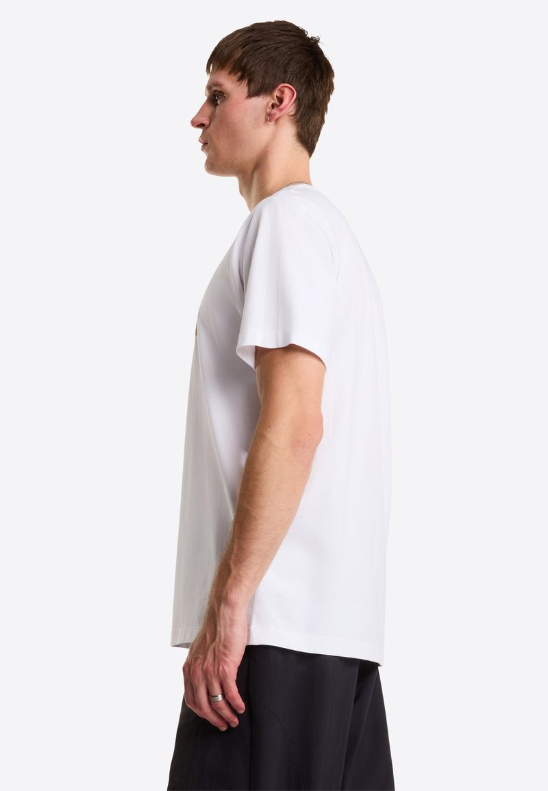 White cotton t-shirt with short sleeves, relaxed fit, and crew neck. Features a small graphic on the chest. Smooth texture, minimal design.