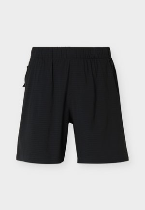 Shorts noirs mi-cuisses avec ceinture élastique et poches latérales, présentés sur un fond clair uni.