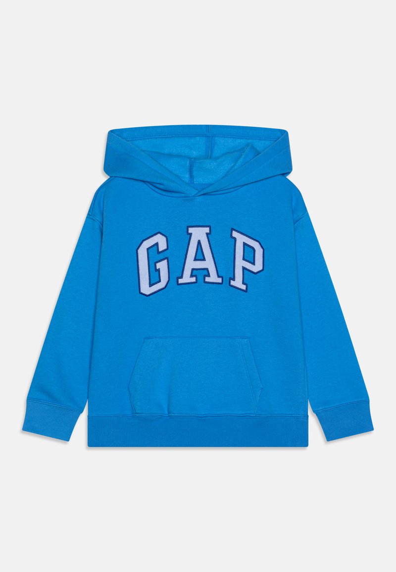 Sininen puuvillaneule, jossa on etutasku ja painettu "GAP"-logo purppuran ja valkoisen sävyissä rinnassa. Mukana säätönyöri hatussa.