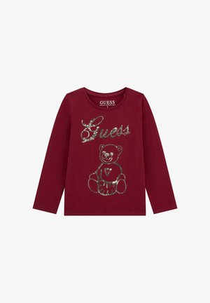 Camicia a maniche lunghe bordeaux con logo "Guess" in paillettes argentate e design di orsacchiotto sul davanti, realizzata in fibra di cotone biologico.