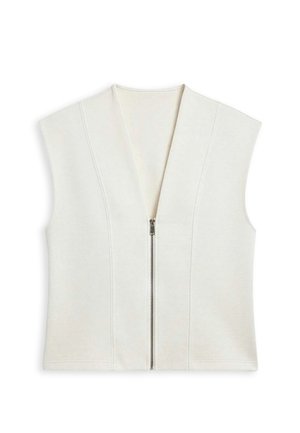 Veste sans manches crème avec un profond col en V et une fermeture éclair à l'avant. Confectionnée dans un tissu doux avec des coutures verticales pour un effet structuré.