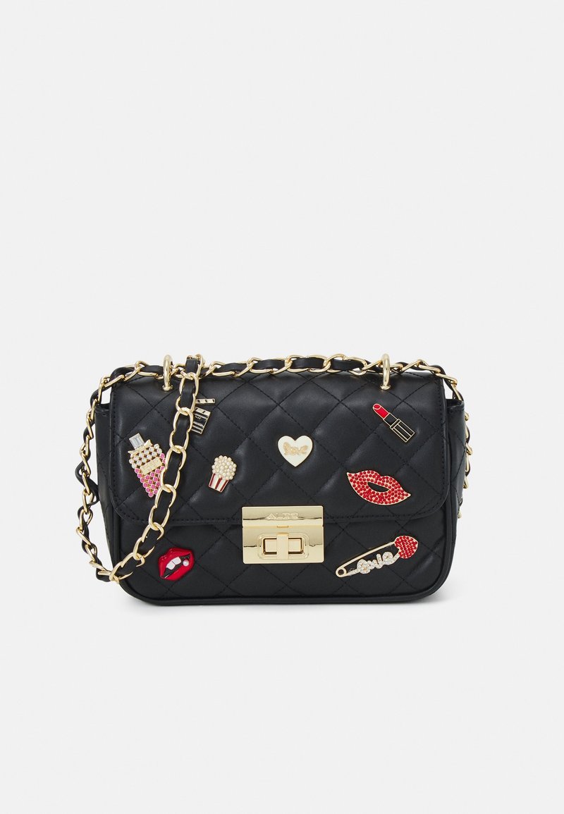 Black quilted bag with gold chain strap, featuring decorative enamel patches: lips, lipstick, popcorn, hearts, and safety pin, gold clasp.