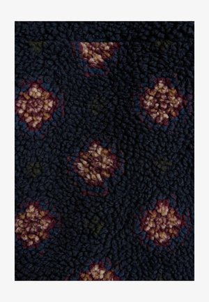 Dark blue fabric featuring a textured surface with a floral pattern in shades of burgundy, cream, and green. Soft, plush material.