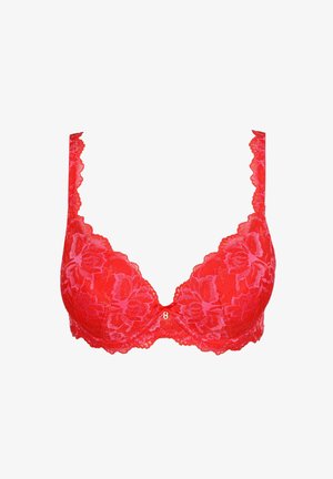 Spitzen-BH in leuchtendem Rot, mit floralen Mustern, verstellbaren Trägern und einem tiefen Ausschnitt. Wellenförmige Kanten entlang der Cups.