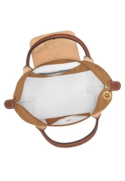 Brown handbag with leather handles, soft tan interior, and a white lining. Features a magnetic snap closure and an interior pocket.