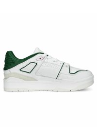 Sneaker with a white leather upper, green accents, padded collar, perforated details, and a textured rubber sole. Lace-up closure.