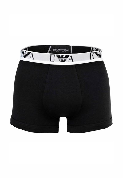 Boxer in cotone nero con fascia elastica bianca in vita con il logo Emporio Armani e l'emblema dell'aquila. Texture liscia, design aderente.