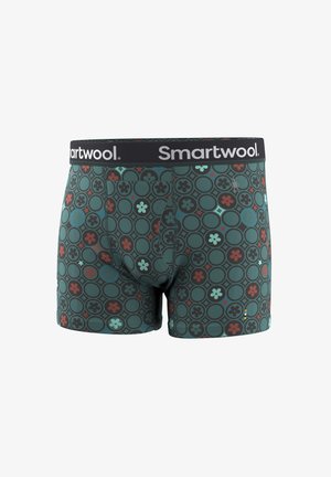 Herenboxers met een groene basis en een circulair bloemmotief in zwart, rood en lichtblauw, voorzien van een zwarte tailleband met het "Smartwool"-logo.
