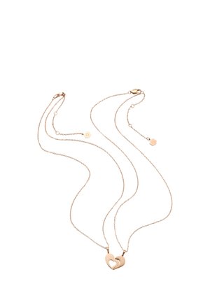 Two delicate gold necklaces with heart-shaped pendants that fit together on a white background.