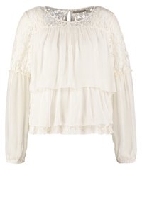 Blouse blanche à volants avec manches longues en dentelle et encolure arrondie. Tissu texturé avec des couches à volants et un bord en dentelle florale à l'ourlet.