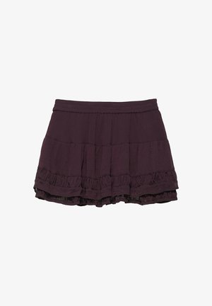 Jupe courte violet foncé avec des volants en étages et une taille élastique froncée sur fond blanc.
