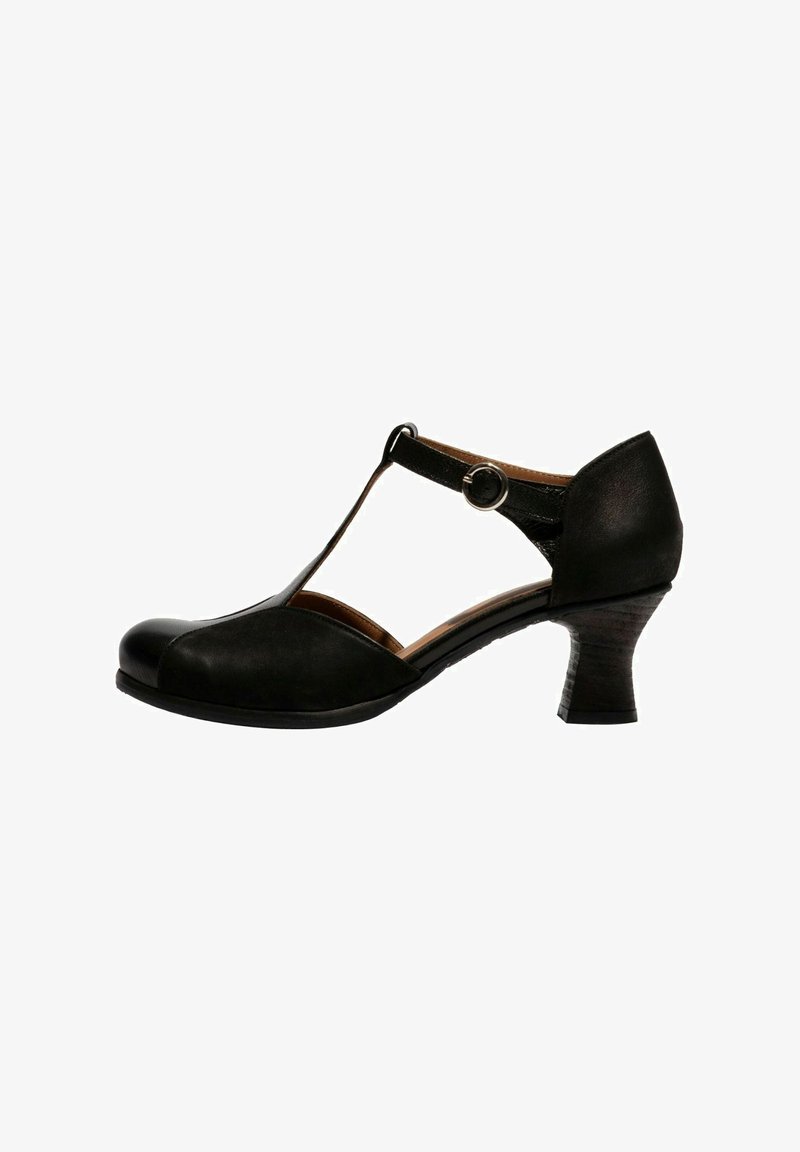 Talons T-strap en cuir noir avec un accent circulaire, bout arrondi et un talon bloc de hauteur moyenne légèrement texturé.
