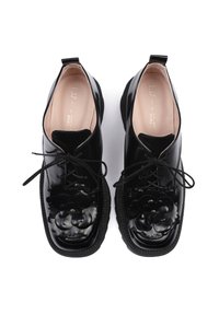Scarpe in pelle nera con decorazioni floreali, punta rotonda, design allacciato e suola in gomma texturizzata. Finitura liscia con accenti a contrasto.