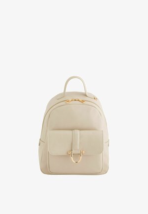 Cream-colored leather backpack with front pocket secured by gold-tone clasp and double zipper on main compartment.