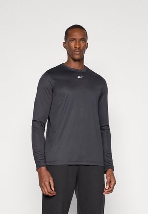 Langärmliges Sportshirt in Schwarz, aus glattem, leichtem Stoff gefertigt. Verfügt über einen Rundhalsausschnitt und ein sichtbares Logo auf der Brust.