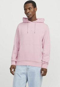 Light pink hooded sweatshirt with a front pocket, ribbed hem, and cuffs; features white logo text on the chest. Made from soft fabric.