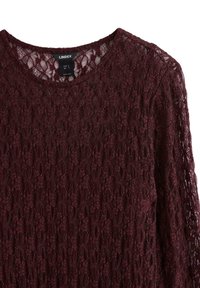 Bordeaux blonde bluse med rund halsudskæring, lange ærmer og indviklede blomster mønstre. Letvægts stof med gennemsigtig tekstur.