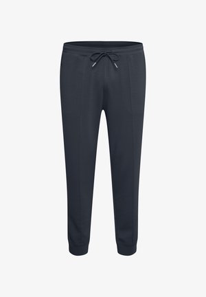 Pantaloni della tuta blu navy con vita elastica, cordoncino, tasche laterali e design a gamba affusolata. Tessuto morbido e superficie liscia.