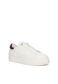 White leather sneaker with a textured finish, round toe, flat laces, and a brown accent at the heel. Features a raised, chunky sole.