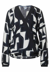 Blusa a righe bianco e nero con scollatura a V, maniche lunghe e orlo elastico. Presenta forme astratte outline in blu.