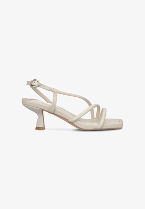 Beige strappy sandal with a block heel, smooth synthetic material, square toe, and adjustable ankle strap with a silver buckle.