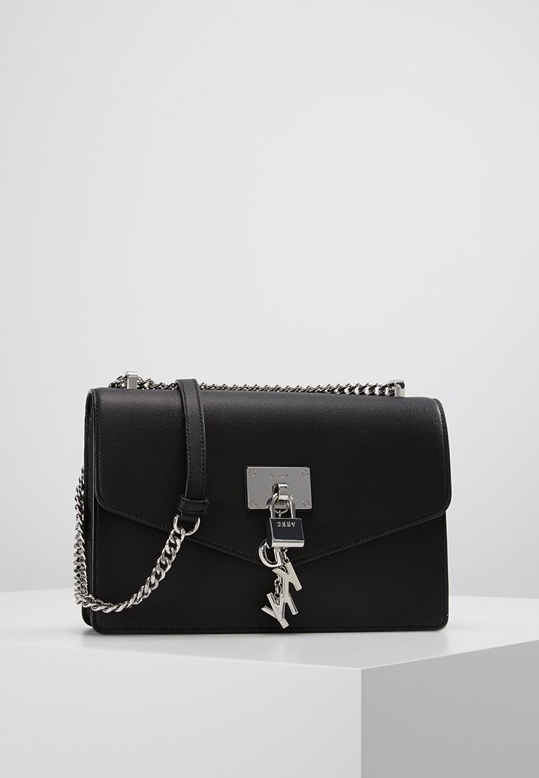 Borsa a tracolla in pelle nera con chiusura a pattina, accessori in argento e tracolla a catena rimovibile. Presenta un charm con logo e una texture liscia.