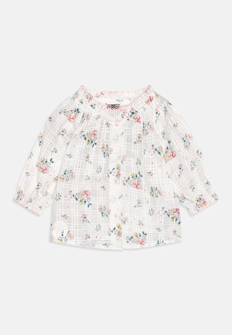 Blouse blanche à motif à carreaux avec imprimé floral multicolore. Présente un col froncé et des manches longues avec poignets élastiques.