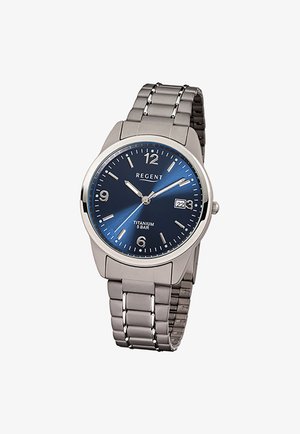 Mens silver titanium watch with blue dial, silver hour markers, date window at 3 o'clock, and metal link bracelet.