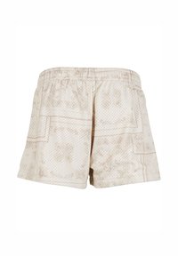 Beige gemusterte Shorts mit atmungsaktivem, netzartigem Material, ausgestattet mit einem elastischen Bund und seitlichen Paspeltaschen.