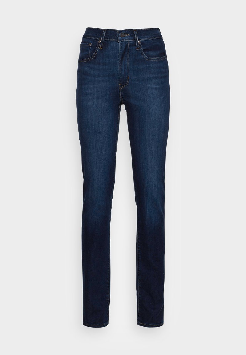 Jeans en denim bleu foncé, taille haute avec une coupe droite. Comprend cinq poches et des coutures visibles le long des coutures.
