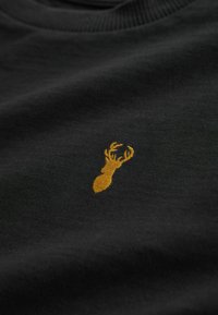 Black fabric t-shirt featuring a golden embroidered lobster design, with a smooth texture and a classic crew neckline.