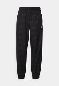 Černé sportovní kalhoty vyrobené z hladké tkaniny, se vzorem opakujícího se loga. Elastický pas a manžety dokončují design.