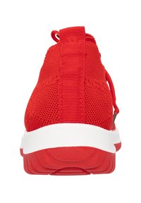 Chaussure de sport rouge avec une tige en tricot texturé, une sangle au talon et une semelle en caoutchouc blanche. Présente un bout arrondi et un design élégant.