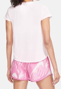 Pink athletic t-shirt with short sleeves and a round neckline, paired with pink patterned shorts featuring stripes and a logo design.
