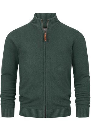 Mörkgrön zip-up cardigan gjort av mjukt stickat material. Har en ribbad krage och manschetter, med en kontrasterande dragkedjedetalj.