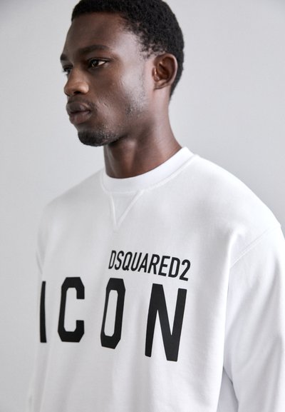 White sweatshirt with black "DSQUARED2 ICON" text. Features a round neckline and ribbed cuffs. Soft, smooth fabric.