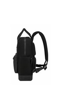 Black backpack with a zip closure, textured fabric, padded straps, and a side pocket. Features a sturdy base designed for durability.