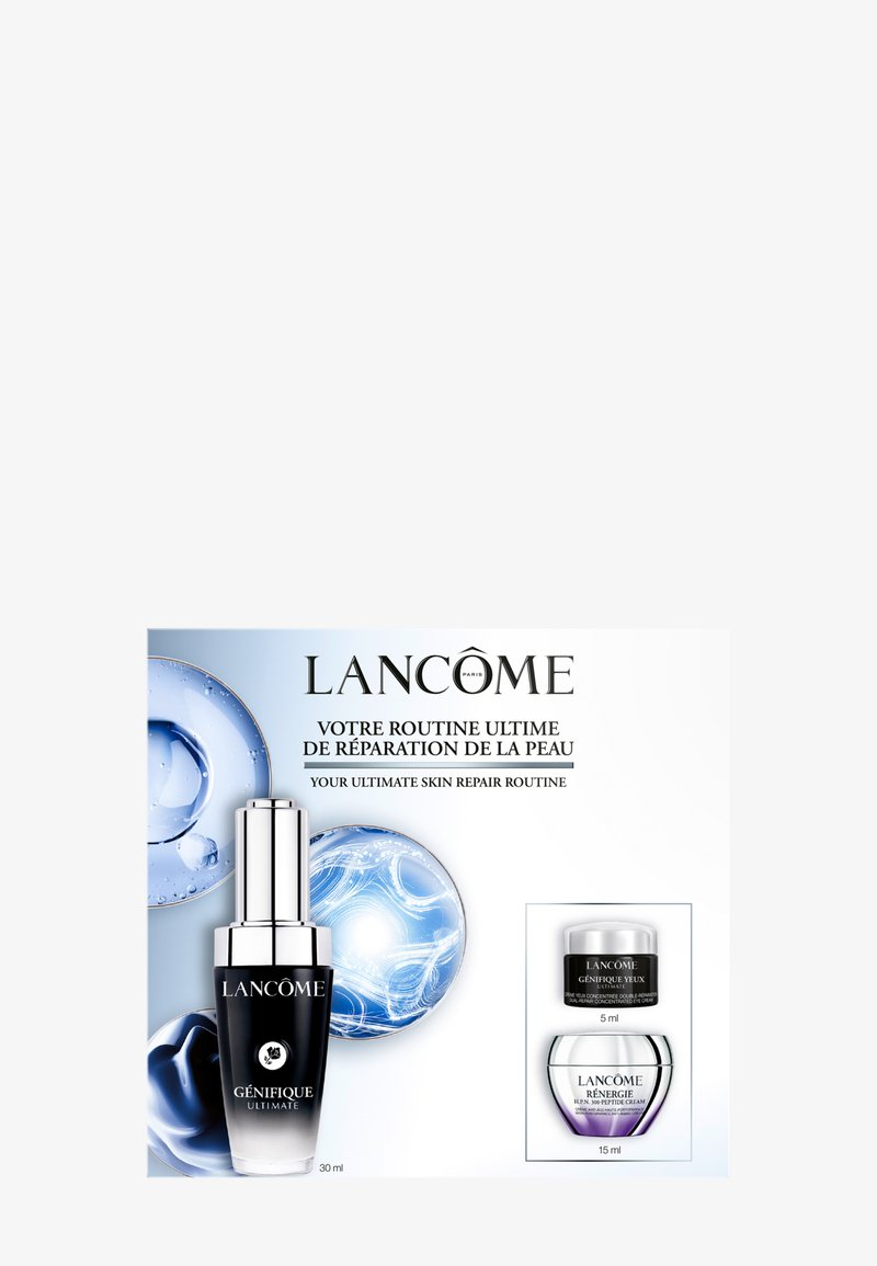 Butelka serum Lancôme Génifique Ultimate z dwoma mniejszymi słoiczkami kremu pod oczy i na twarz, promująca kompleksową rutynę naprawy skóry.
