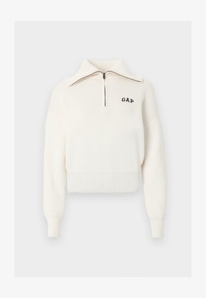 Valge soonikkoes kampsun pikkade varrukatega, veerand lukuga krae ja väike must "GAP" logo vasakul rinnal.