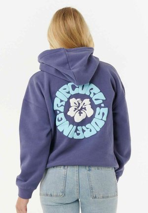 Sweat à capuche violet avec un grand graphique blanc d'hibiscus et un texte teal au dos. Il dispose d'une capuche avec cordon de serrage et d'une coupe ample, fabriqué en tissu doux.