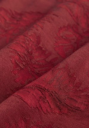 Burgundy fabric with a textured floral pattern, showcasing intricate detailing and a smooth appearance, draped in soft folds.