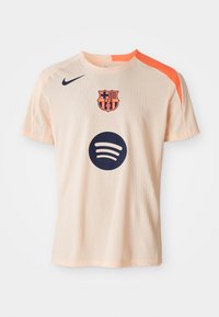 Light peach FC Barcelona soccer jersey with orange shoulder stripe, navy Nike logo, team crest, and Spotify sponsor logo on front.